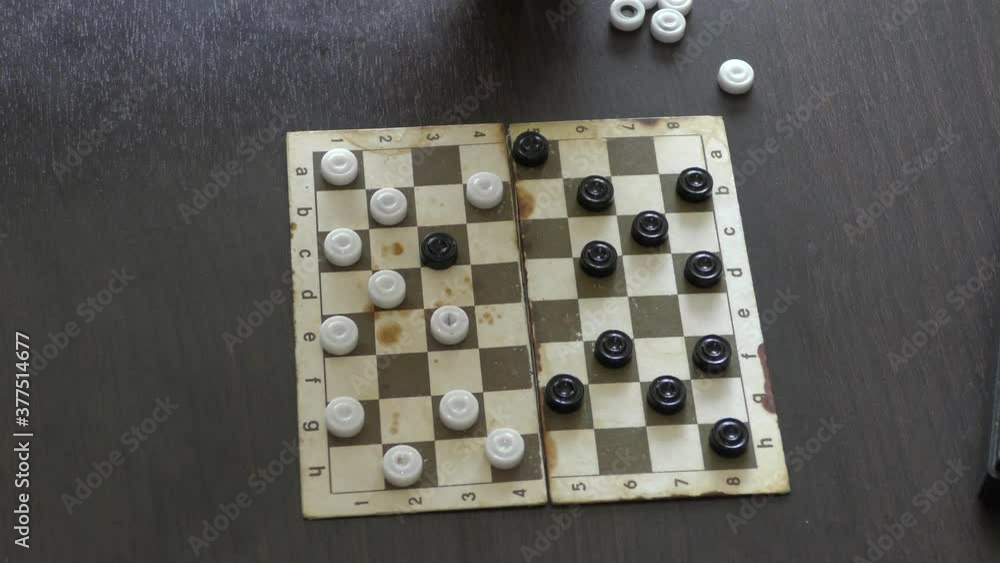 a man plays a game of checkers a man plays a game of checkers