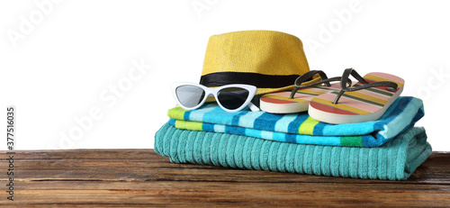 Composition with different beach objects on wooden table, white background