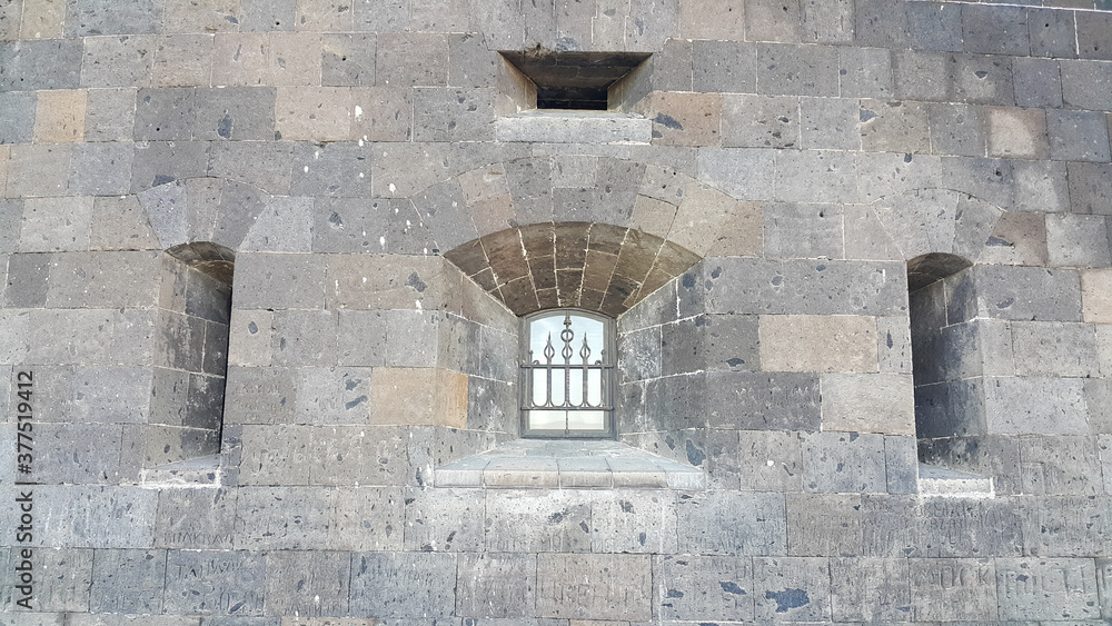 Naklejka premium A window with bars on the Old castle from the outside.
