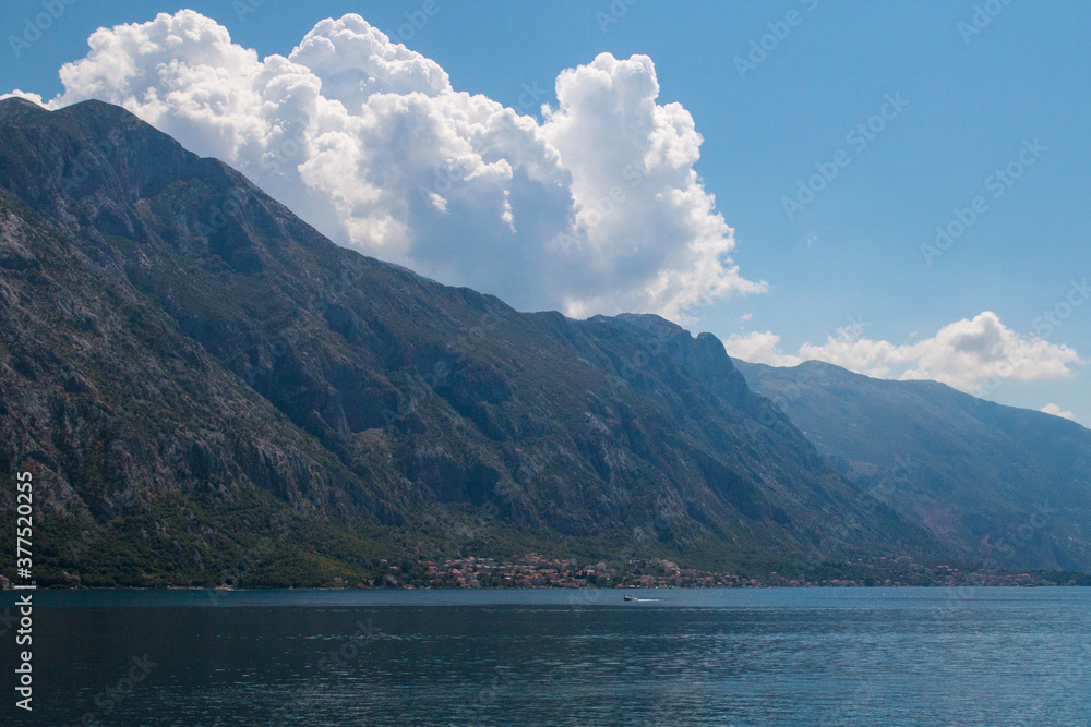 Bay of Kotor from the heights. View from Mount Lovcen to the bay. View down from the observation platform on the mountain Lovcen. Mountains and bay in Montenegro. The liner near the old town of Kotor.