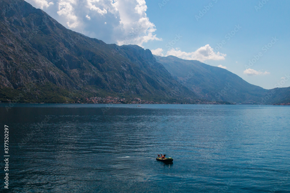 Bay of Kotor from the heights. View from Mount Lovcen to the bay. View down from the observation platform on the mountain Lovcen. Mountains and bay in Montenegro. The liner near the old town of Kotor. Bay of Kotor from the heights. View from Mount Lovcen to the bay. View down from the observation platform on the mountain Lovcen. Mountains and bay in Montenegro. The liner near the old town of Kotor.