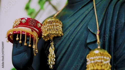 golden jewelry of bracelet and necklace rolling camera decorated by Buddha Statue