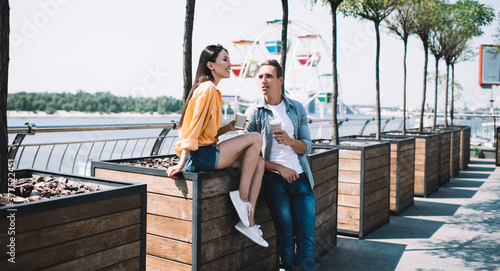 Relaxed guy communicating with girlfriend in street