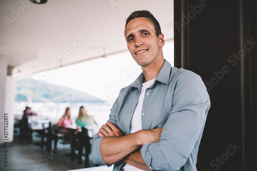 Confident casual man standing in cafe