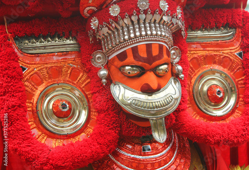 Theyyam, KANNUR - APRL27: A Theyyam artist performs during the annual festival at Ramapuram,Puliroopakaali temple on April 27, 2017 in Kannur, India.Theyyam is a ritualistic folk art form of Kerala photo