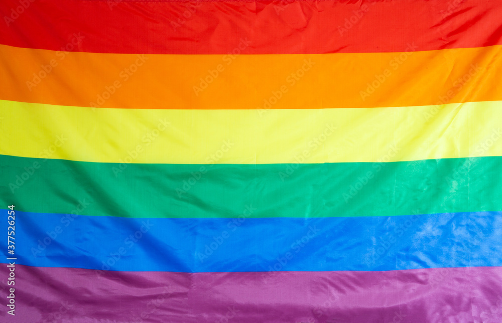 The rainbow flag, commonly the gay pride flag and sometimes the LGBT pride flag, is a symbol of lesbian, gay, bisexual, and transgender LGBT pride and LGBT social movements background texture The rainbow flag, commonly the gay pride flag and sometimes the LGBT pride flag, is a symbol of lesbian, gay, bisexual, and transgender LGBT pride and LGBT social movements background texture