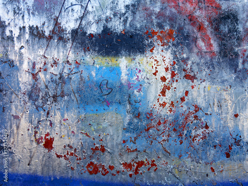 Abstract, damage to walls with many colors. Style of landscape. Rough concrete surface with cracks, scratches and paint stains. Great background or texture.