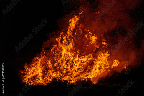 big bonfire with smoke. Flames of a campfire in the night photo