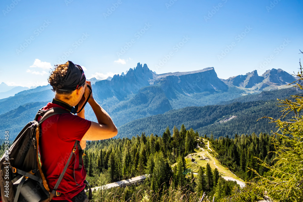 Photographer shooting from Tofane di Rozes towards the Venetian Dolomites, Italy
