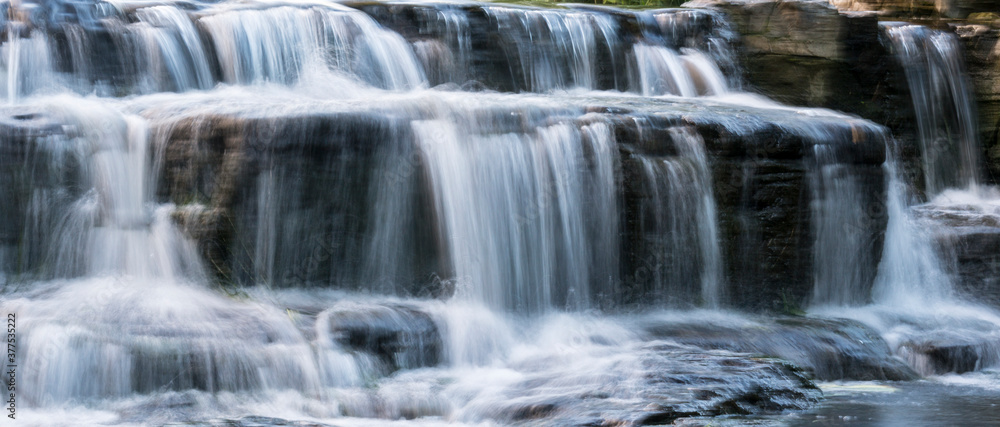 panoramic view of a small stream. waterfall in the forest panoramic view of a small stream. waterfall in the forest