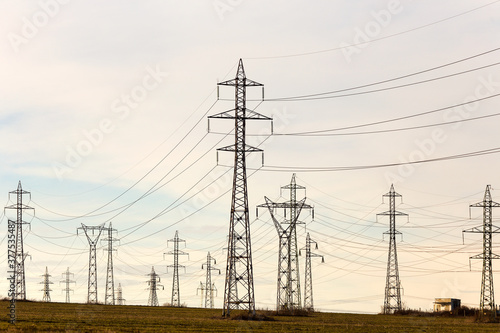 Wallpaper Mural High voltage lines and power pylons in a flat and green agricultural landscape on a sunny day with cirrus clouds in the blue sky. Pylon and transmission power line Torontodigital.ca