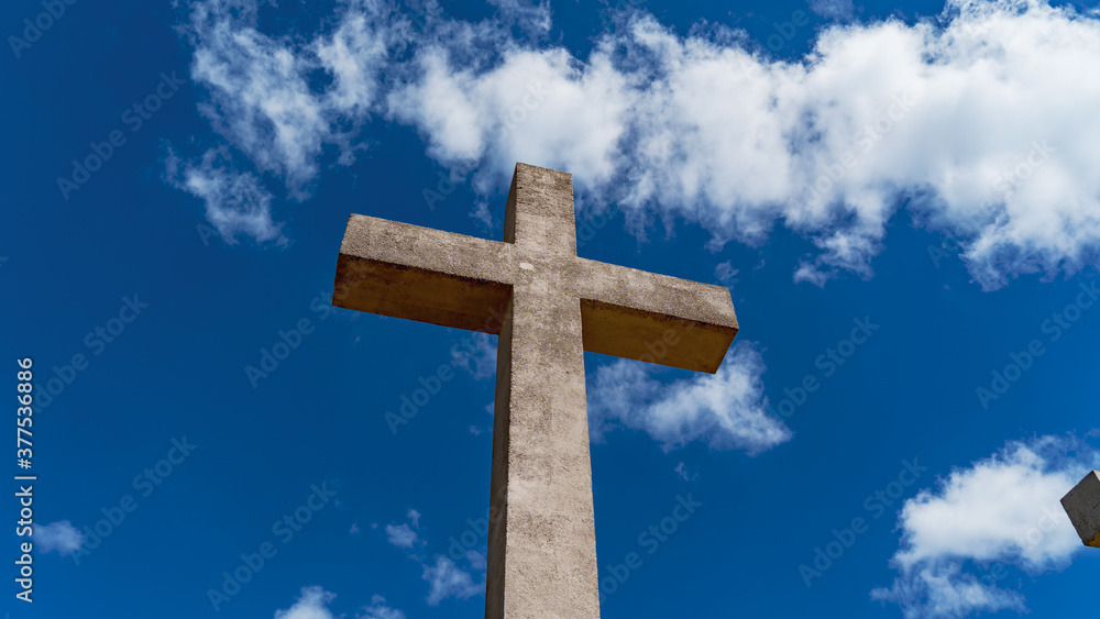 A concrete cross against a blue sky (Puy de Sarran)	
