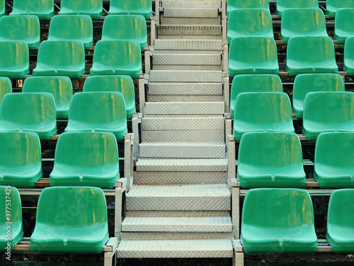 Amphitheater dark green seats abstract background. Places in the stands of the stadium