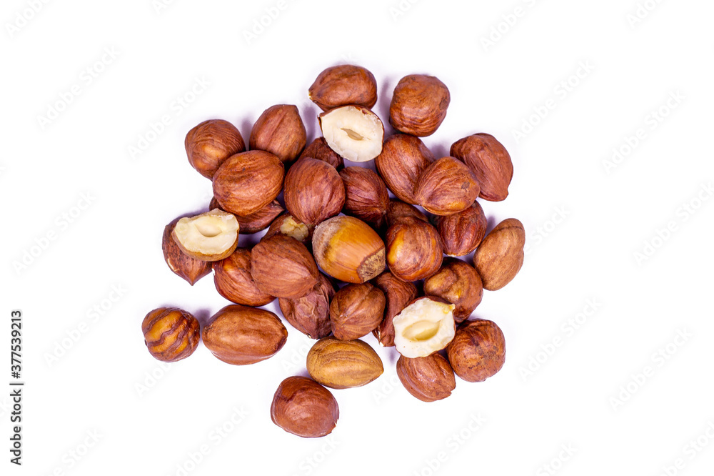 Peeled brown hazelnut heap isolated on white background. Peeled brown hazelnut heap isolated on white background.