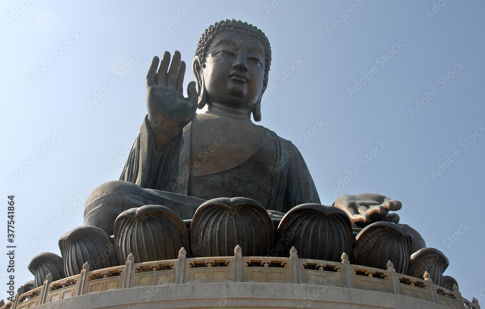 Fototapeta premium The Big Buddha or Tian Tan Buddha on Lantau Island, Hong Kong, China. The Buddha Shakyamuni statue is at Ngong Ping near Po Lin Monastery on Lantau. Close up view of the Buddha statue.