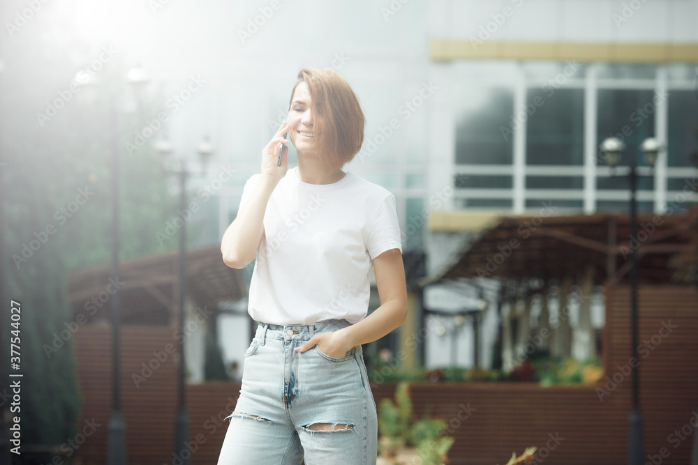 Attractive girl with phone in the street