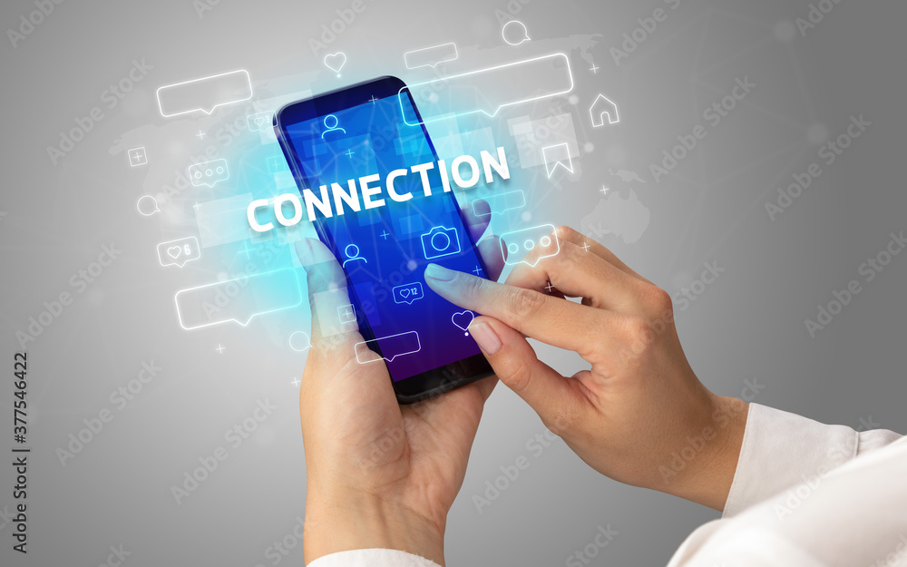 Female hand typing on smartphone with CONNECTION inscription, social media concept Female hand typing on smartphone with CONNECTION inscription, social media concept