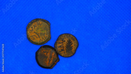 Judaea Judea Biblical WIDOW'S MITE Related Ancient Coin LEPTON Holy Land Hasmoneans and Jesus Times Currency Jerusalem Mint.  On blue background. photo
