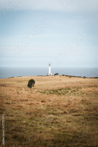 Faro de Luces, picturesque white lighthouse and the view on the Atlantic ocean in Asturias, Spain photo