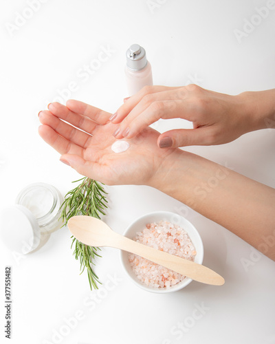 Hands applying cream. Spa organic treatment with herbs salt and lotion. Close up 