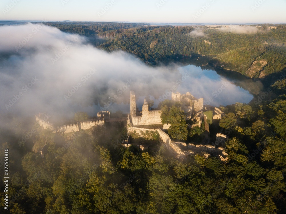 Cornstein Medieval castle in South Moravia region during amazing sunrise, Czech republic, Europe. Aerial drone view. Summer or autumn time.
Misty and sunny atmosphere.