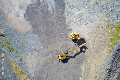 Construction site yellow diggers aerial view