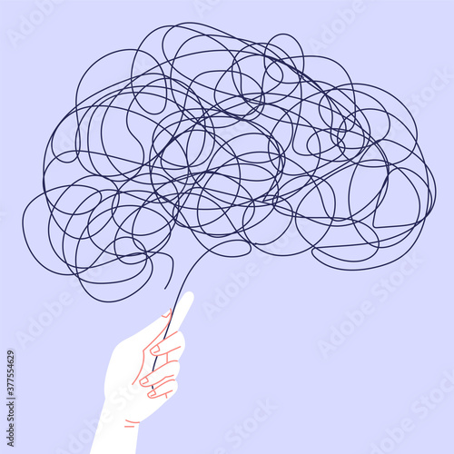 Mental health self help concept. Tangled thread formed as a human brain. A hand holding one of the threads ends. Abstract image of mental health problems