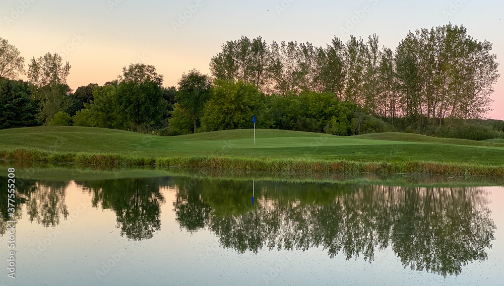 sunrise golf course golf green white blue flag morning dew