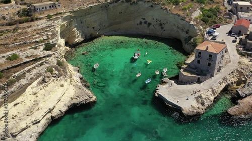 Aerial drone video of beautiful fishing seaside village of Mezapos with crystal clear emerald beach in Mani Peninsula, Lakonia prefecture, Peloponnese, Greece photo