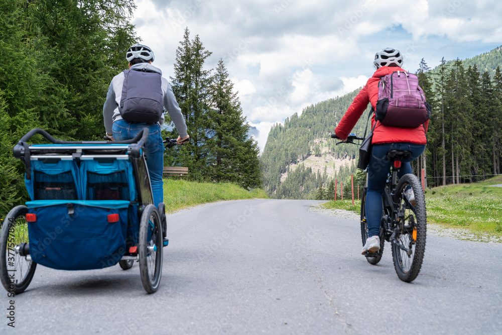 Family With E Bike MTB And Kid Trailer