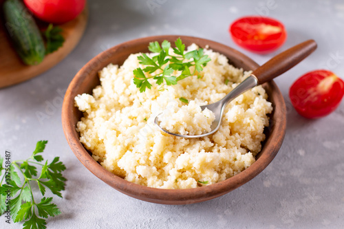Couscous with parsley in the bowl. Concept of Healthy Food.