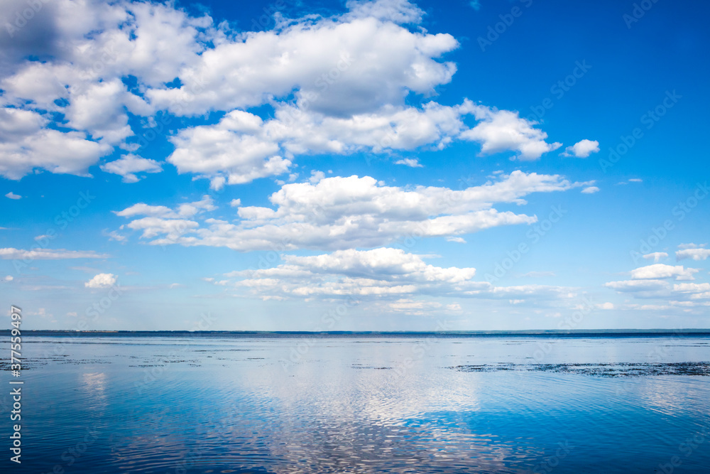 Beautiful blue cloudy sky and its reflection in water