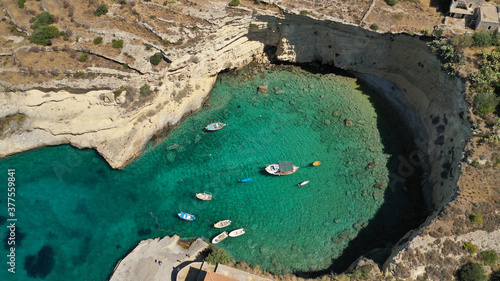 Aerial drone photo of beautiful fishing seaside village of Mezapos with crystal clear emerald beach in Mani Peninsula, Lakonia prefecture, Peloponnese, Greece