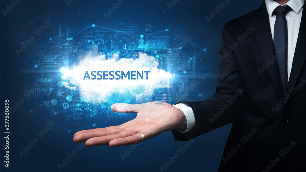 Hand of Businessman holding ASSESSMENT inscription, successful business concept Hand of Businessman holding ASSESSMENT inscription, successful business concept