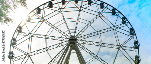 Ferris wheel in an amusement park. Outdoor entertainment.
