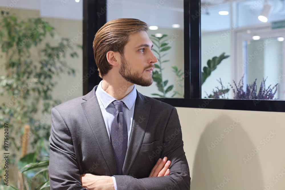 Portrait of happy businessman with arms crossed standing in office. Portrait of happy businessman with arms crossed standing in office.