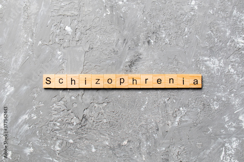 schizophrenia word written on wood block. schizophrenia text on table, concept photo