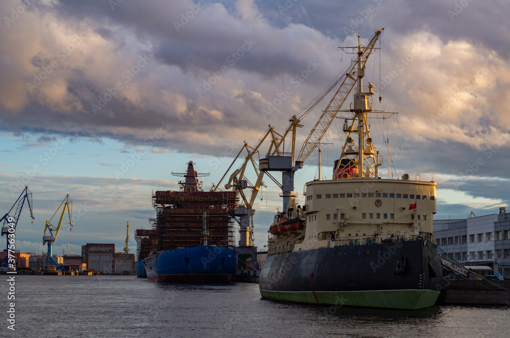 Fototapeta premium Shipyards at sunset in autumn.Shipbuilding in Russia.