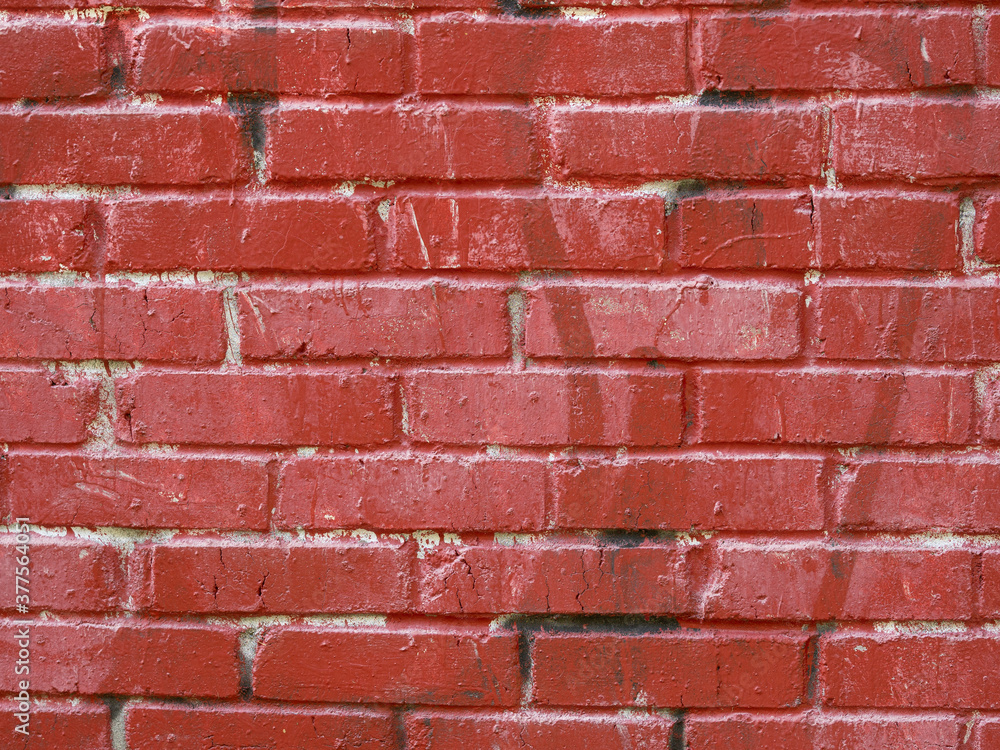 Obraz premium A wall of painted bricks. Textured red background.