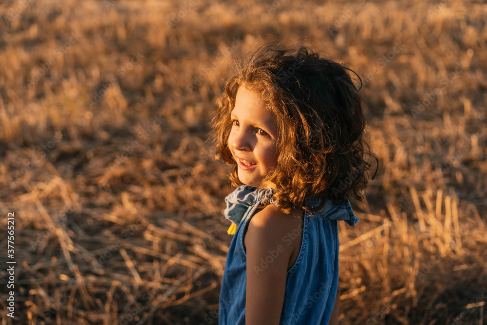 Portrait of Young girl while playing happily in the field Portrait of Young girl while playing happily in the field