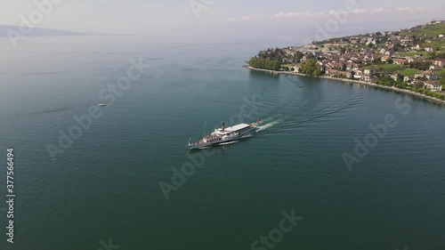 Steam boat leaving Cully harbor in Lavaux, Switzerland. photo