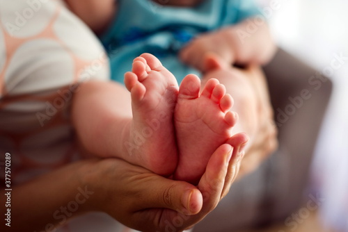 infant's feet in the mother's hand