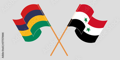 Crossed and waving flags of Mauritius and Syria