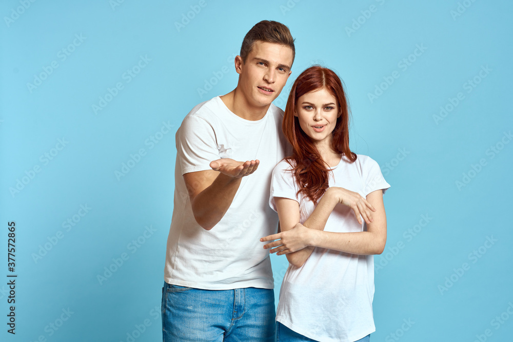 Young woman and man stinks relationship on blue background cropped view of couple in love Young woman and man stinks relationship on blue background cropped view of couple in love