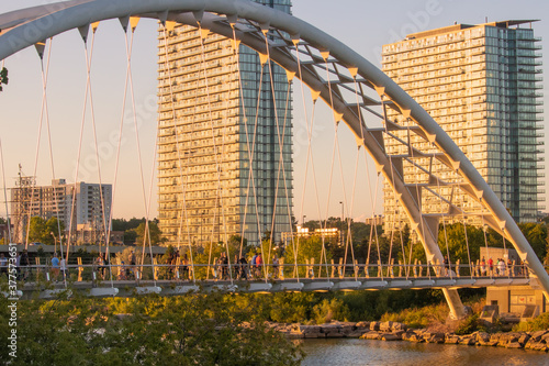Pedestrian Arch Bridge in Front of Highrise Apartment Buildings