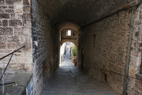 alley with arch in the medieval town of gubbio umbria italy