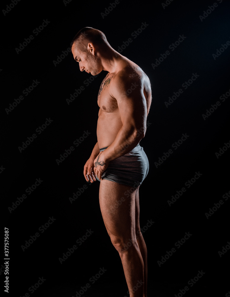 Handsome man with big muscles, posing at the camera Handsome man with big muscles, posing at the camera