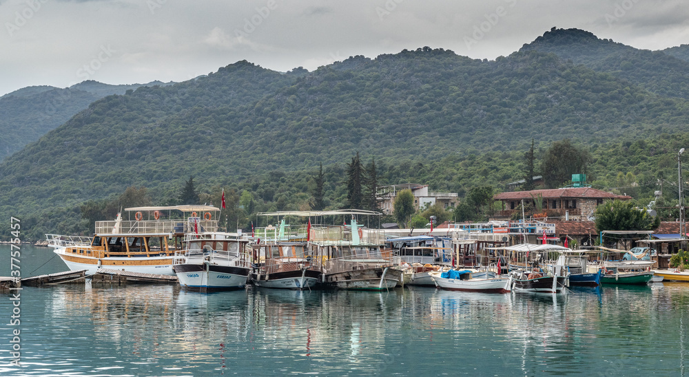 Kalekoy village harbour on Kekova island with boats and small ships docked on the water