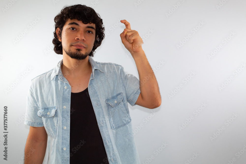 young hispanic deaf man using sign language to communicate, on a white background wearing casual clothes young hispanic deaf man using sign language to communicate, on a white background wearing casual clothes