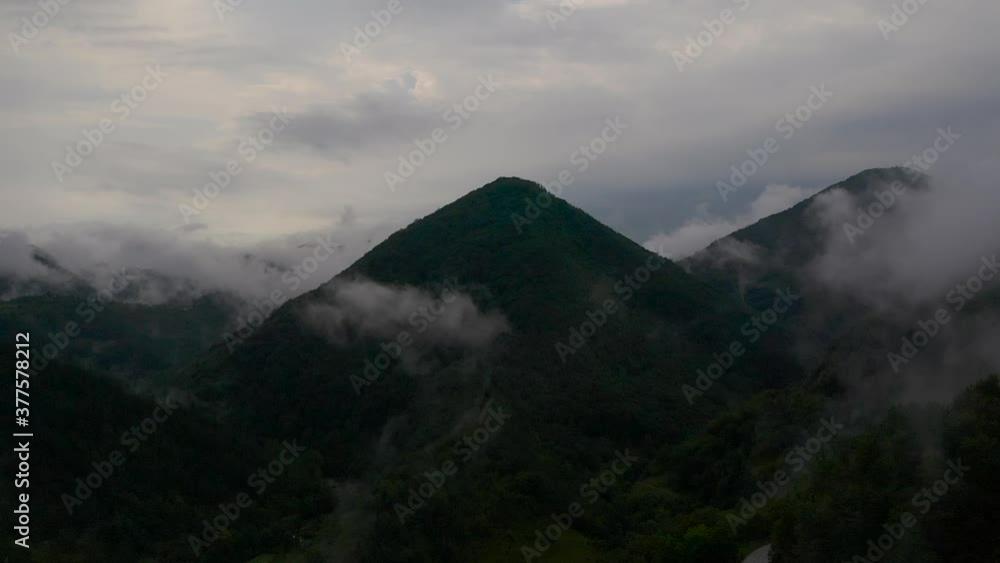 Aerial shot of camera flying through the clouds, towards a mountain that looks like a pyramid. Aerial shot of camera flying through the clouds, towards a mountain that looks like a pyramid.